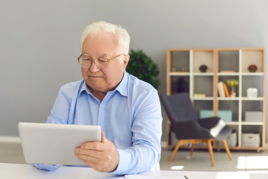 un hombre mayor mirando una tablet